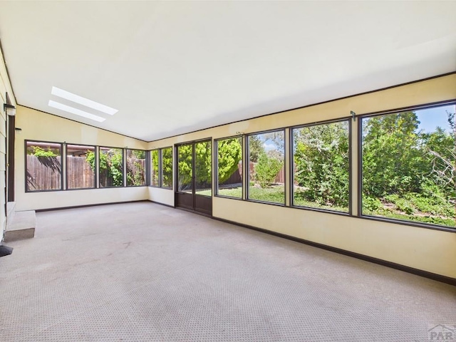 9 Woodsorrel Ct, Pueblo, CO 81001 - unfurnished sunroom featuring a skylight, lofted ceiling, carpet, and baseboards