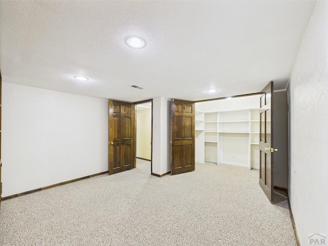 9 Woodsorrel Ct, Pueblo, CO 81001 - unfurnished bedroom with light colored carpet, a textured ceiling, recessed lighting, baseboards, and a closet