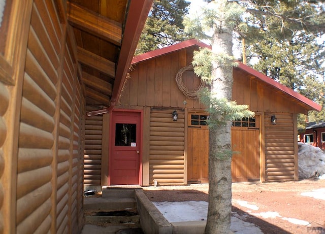 entrance to property featuring faux log siding