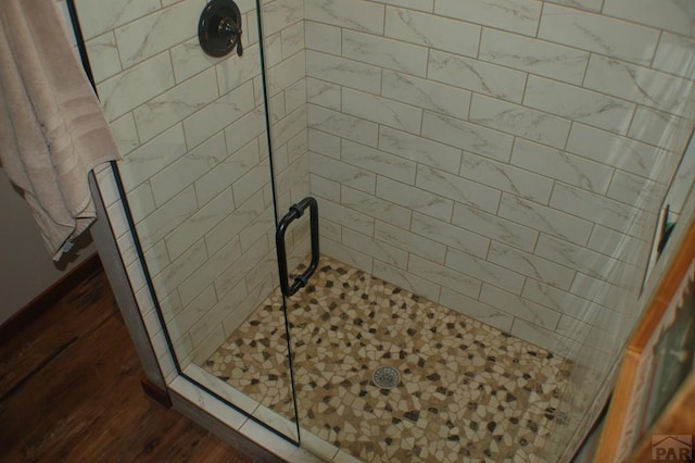 bathroom featuring a stall shower and wood finished floors