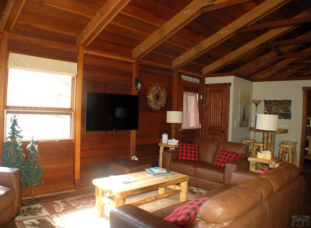 living room featuring lofted ceiling with beams, wooden walls, wood finished floors, and wood ceiling