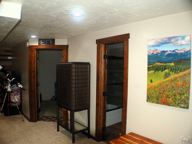 hall featuring recessed lighting, a textured ceiling, and carpet