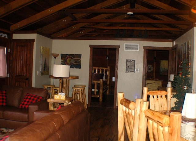 living room featuring visible vents, lofted ceiling, and wood finished floors