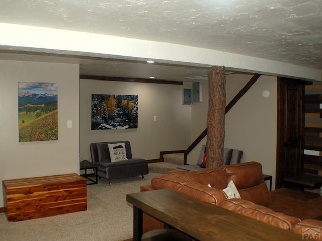 carpeted living area with stairway and a textured ceiling