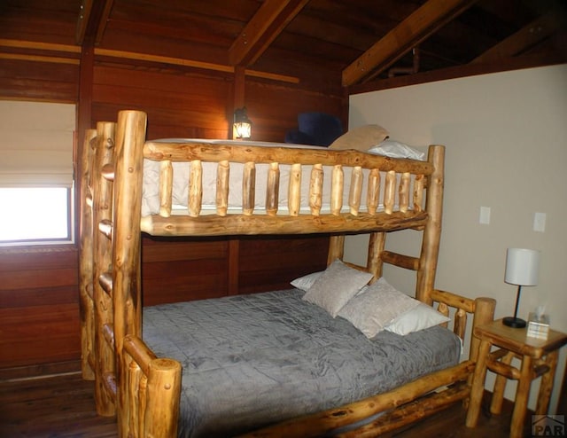 bedroom with wood finished floors, beam ceiling, and wooden ceiling