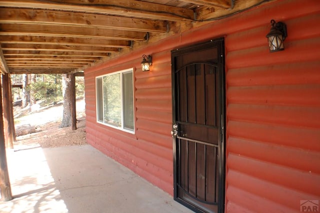 entrance to property featuring log veneer siding