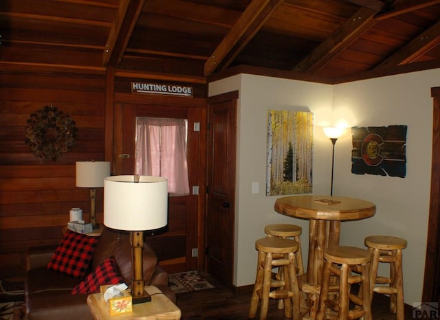 interior space with beam ceiling, wood finished floors, and wood ceiling