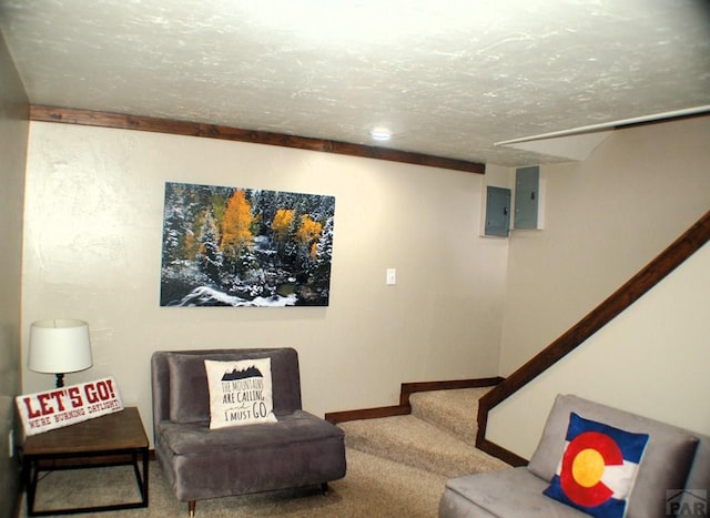 living room with baseboards, carpet, stairway, electric panel, and a textured ceiling