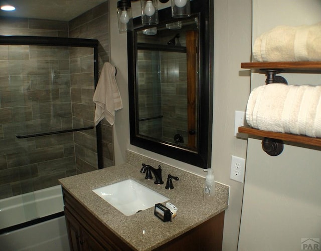 bathroom featuring vanity and shower / bath combination with glass door