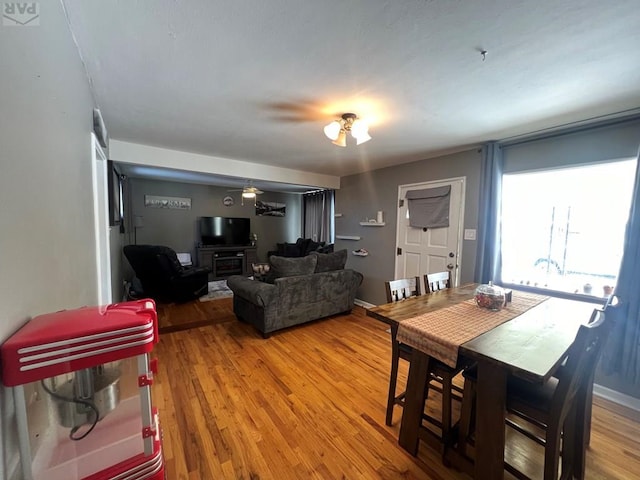 dining area featuring baseboards and wood finished floors