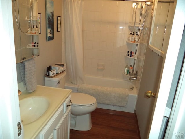 full bath featuring toilet, vanity, wood finished floors, and shower / bath combination with curtain