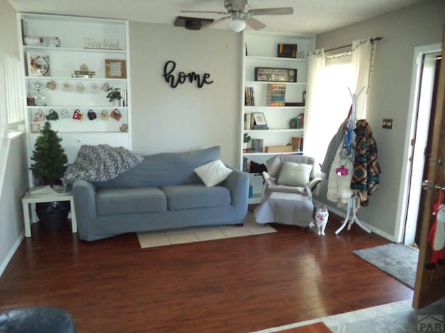 living room featuring wood finished floors and a ceiling fan