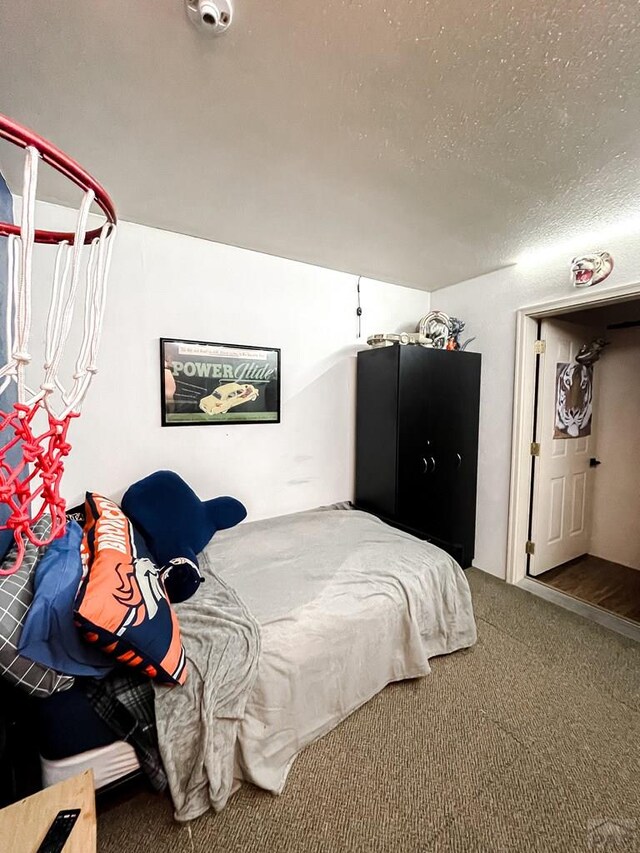 bedroom featuring carpet and a textured ceiling