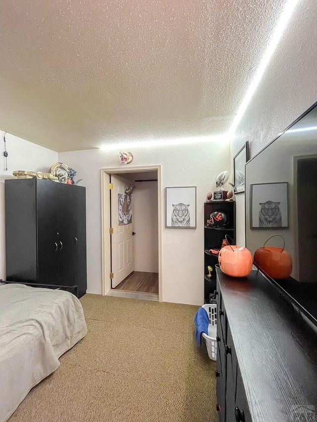 carpeted bedroom featuring a textured ceiling