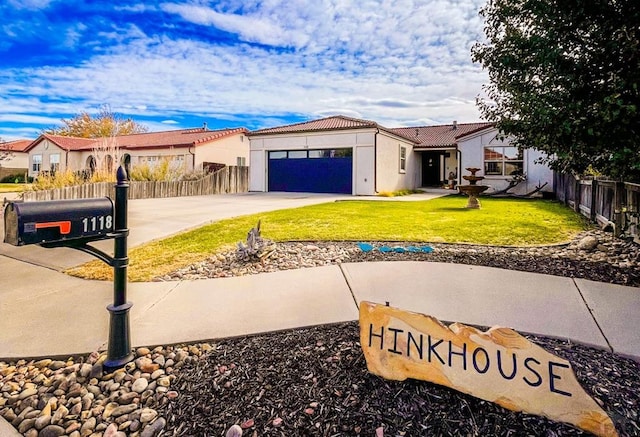 exterior space featuring a garage, a residential view, concrete driveway, and fence