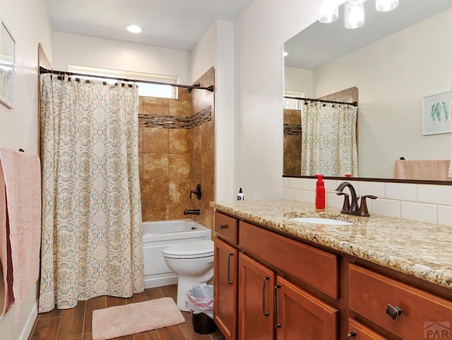 bathroom with toilet, wood finished floors, vanity, and shower / bathtub combination with curtain