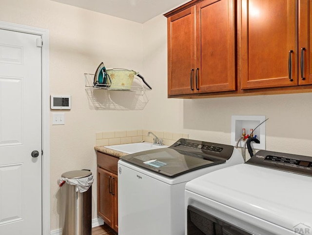 laundry room featuring cabinet space, a sink, and washing machine and clothes dryer