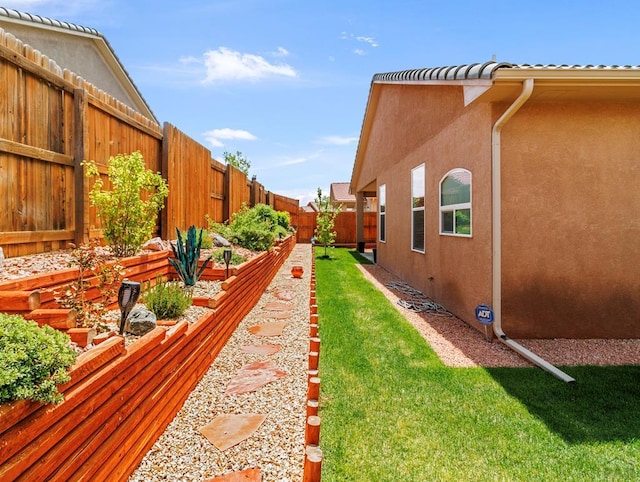 view of yard featuring a fenced backyard and a garden