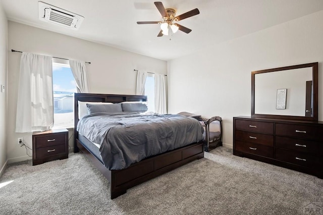 bedroom featuring ceiling fan, visible vents, baseboards, and light colored carpet