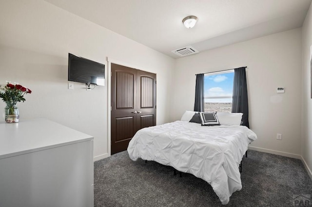 carpeted bedroom with baseboards, visible vents, and a closet