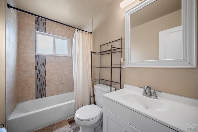 full bath with toilet, shower / bath combo with shower curtain, and vanity
