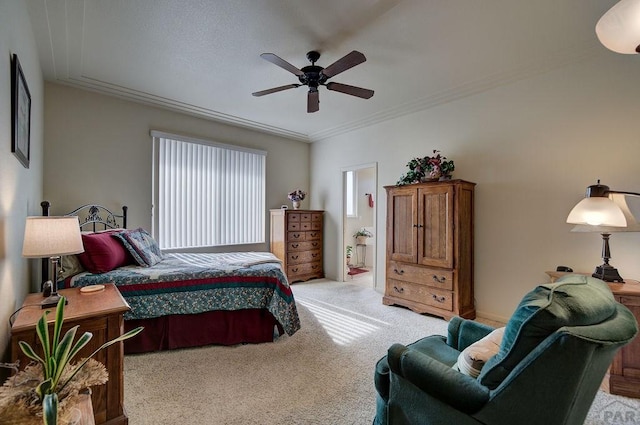 bedroom with light carpet, ensuite bath, crown molding, and ceiling fan