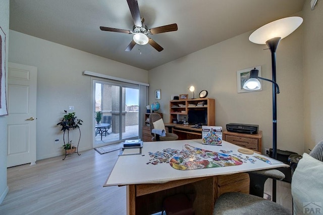 home office with baseboards, light wood finished floors, and a ceiling fan