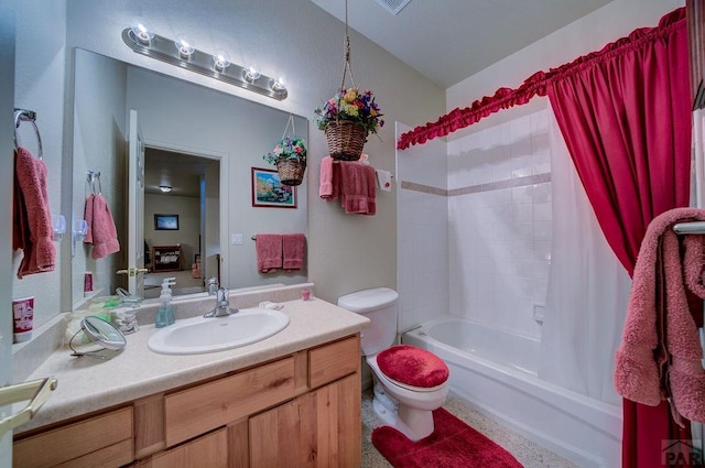 bathroom with shower / bath combination with curtain, vanity, and toilet