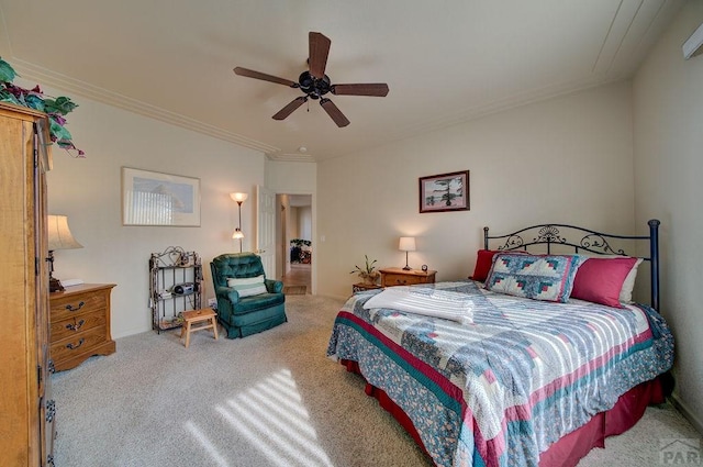 carpeted bedroom with ornamental molding and a ceiling fan