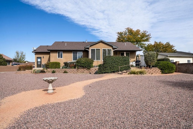 single story home with roof with shingles, stucco siding, and fence