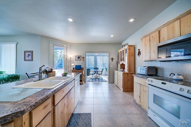 kitchen with white appliances, tasteful backsplash, recessed lighting, a sink, and a toaster