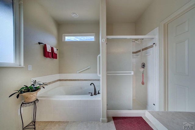 full bath with tile patterned flooring, a bath, and a stall shower