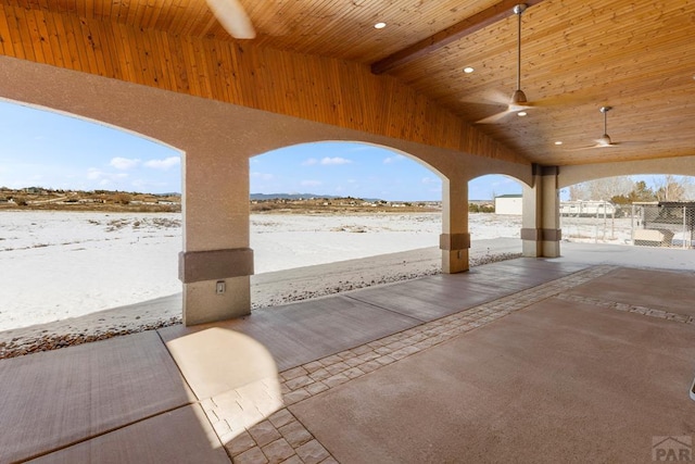 snow covered patio with a ceiling fan