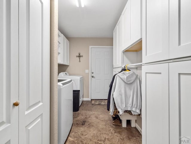 laundry room with baseboards, cabinet space, and washing machine and clothes dryer