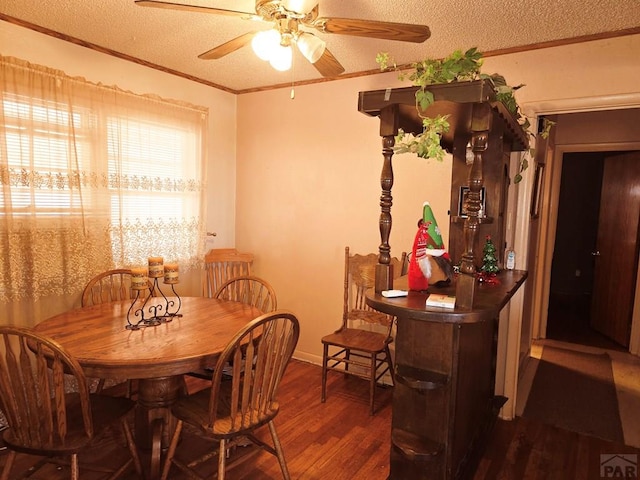 dining area featuring crown molding, a textured ceiling, a ceiling fan, and wood finished floors