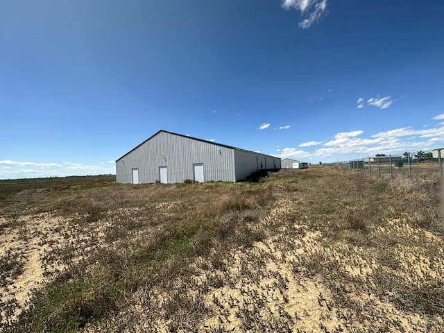 view of pole building featuring a rural view