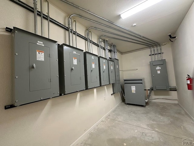 utility room featuring a garage and electric panel