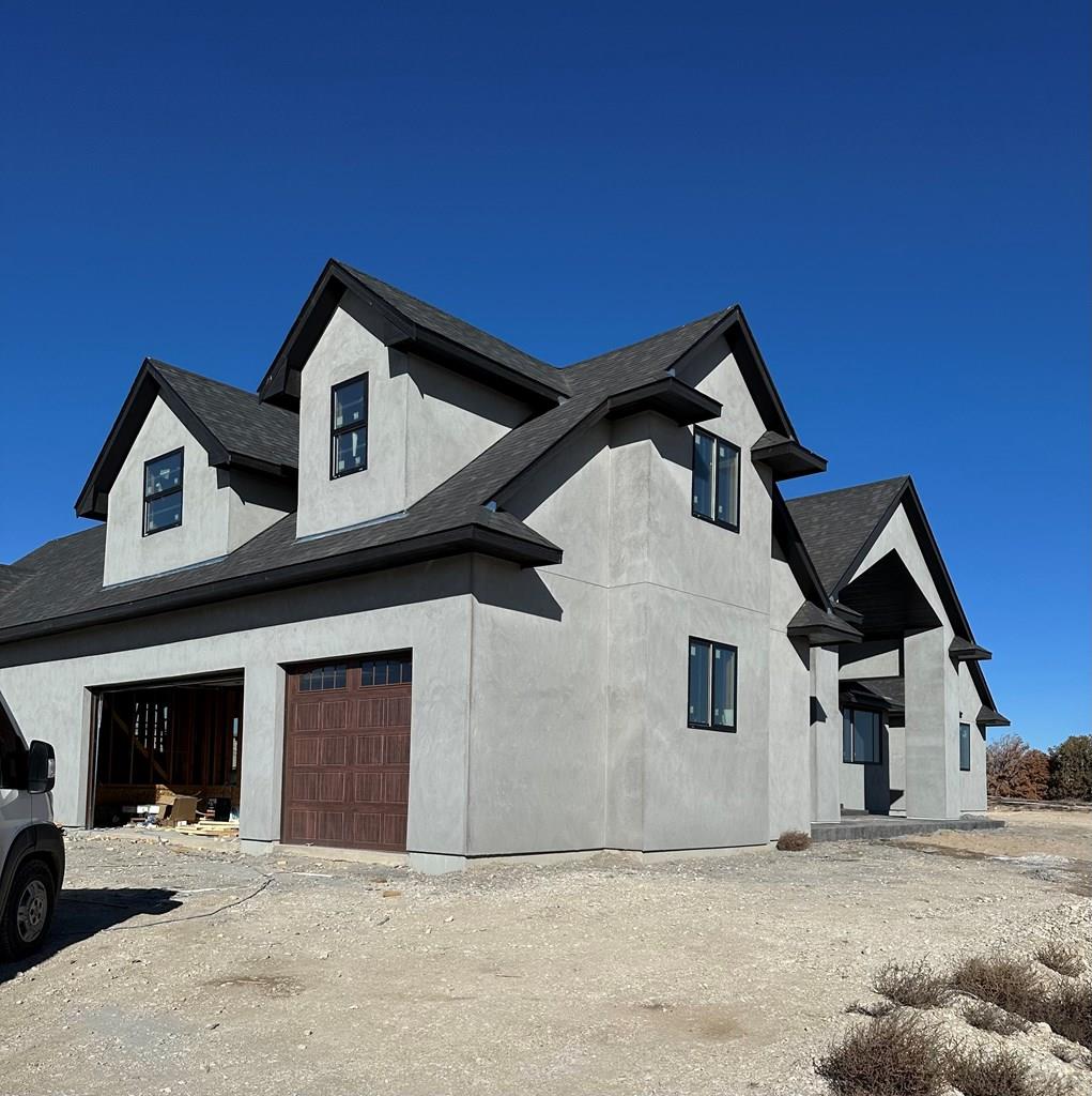 view of property exterior featuring an attached garage and stucco siding