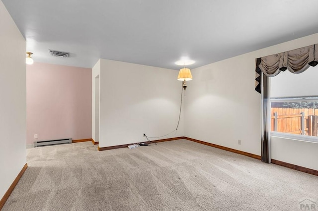 carpeted empty room with baseboards, visible vents, and a baseboard radiator