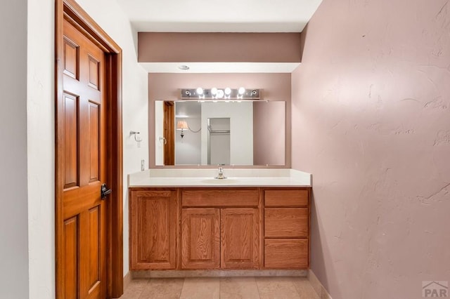 bathroom featuring baseboards, vanity, and tile patterned flooring