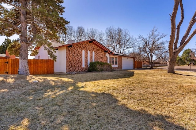 view of property exterior featuring a yard, a garage, and fence