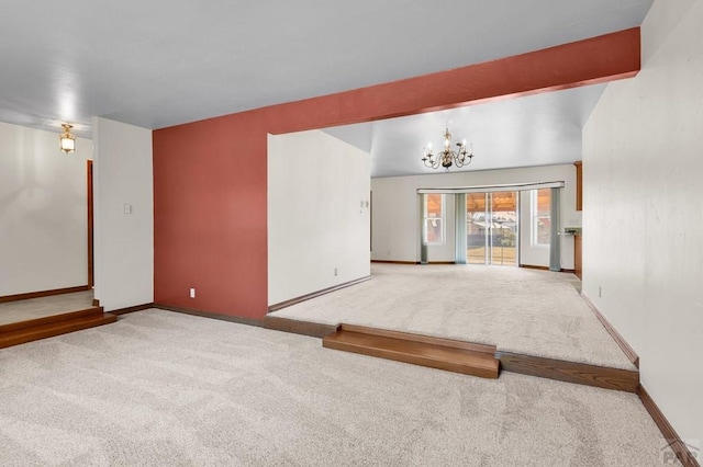 spare room featuring carpet flooring, beamed ceiling, baseboards, and an inviting chandelier