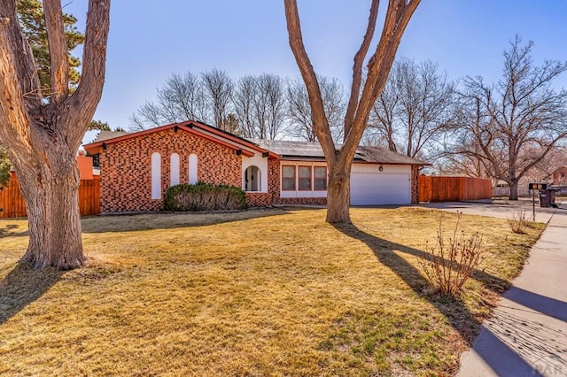 view of front of home with concrete driveway, an attached garage, fence, and roof mounted solar panels