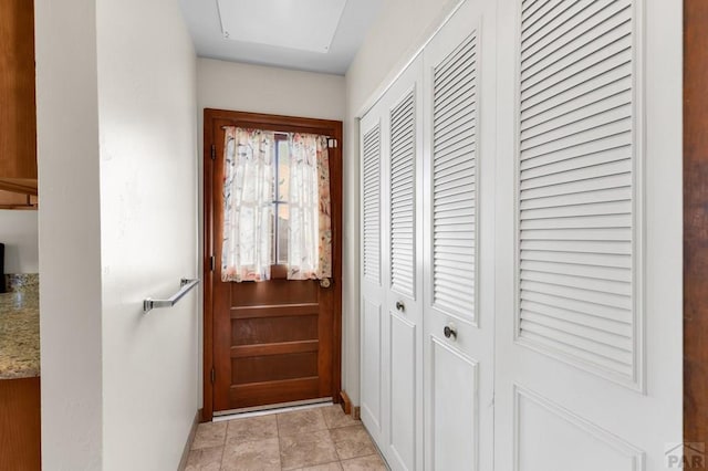 entryway with light tile patterned floors