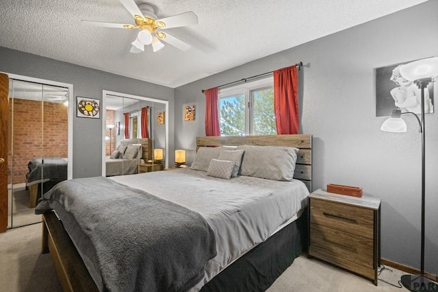 bedroom with a textured ceiling, ceiling fan, baseboards, and light colored carpet