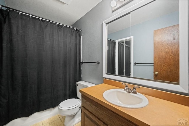 bathroom featuring toilet, vanity, and tile patterned floors