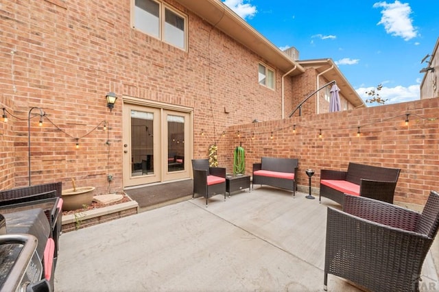 view of patio featuring fence and an outdoor hangout area