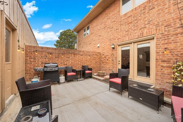 view of patio featuring fence and grilling area