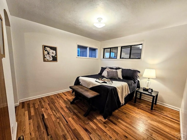 3112 Withers Ave, Pueblo, CO 81008 - bedroom featuring dark wood-style floors, baseboards, and a textured ceiling