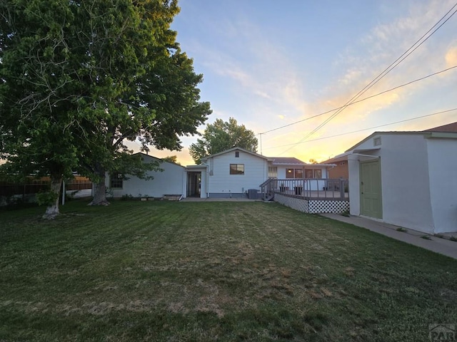 3112 Withers Ave, Pueblo, CO 81008 - yard at dusk featuring a wooden deck and a yard